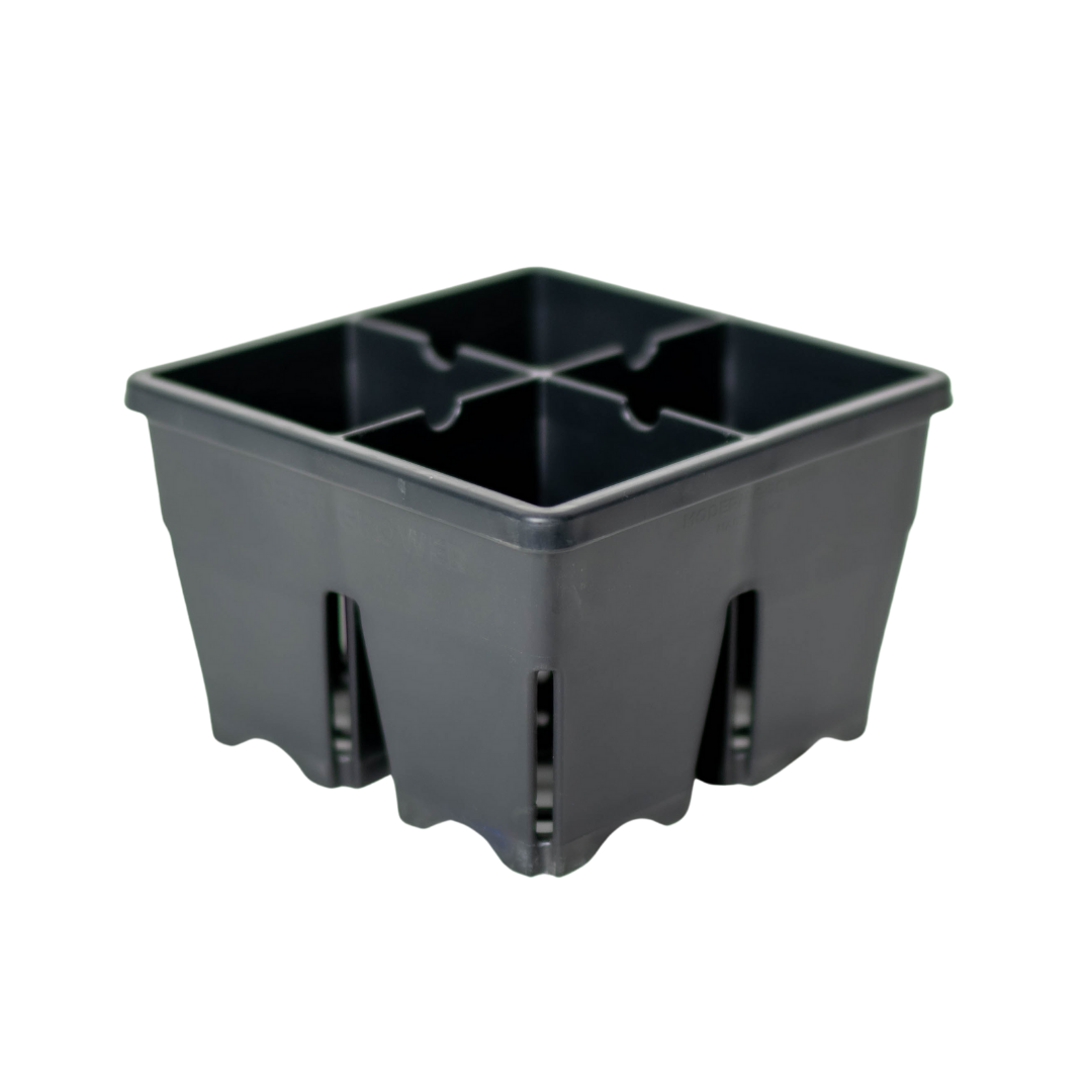Black plastic seed starting tray divided into four equal square cells with ribbed, vented sides, shown empty against a white background.
