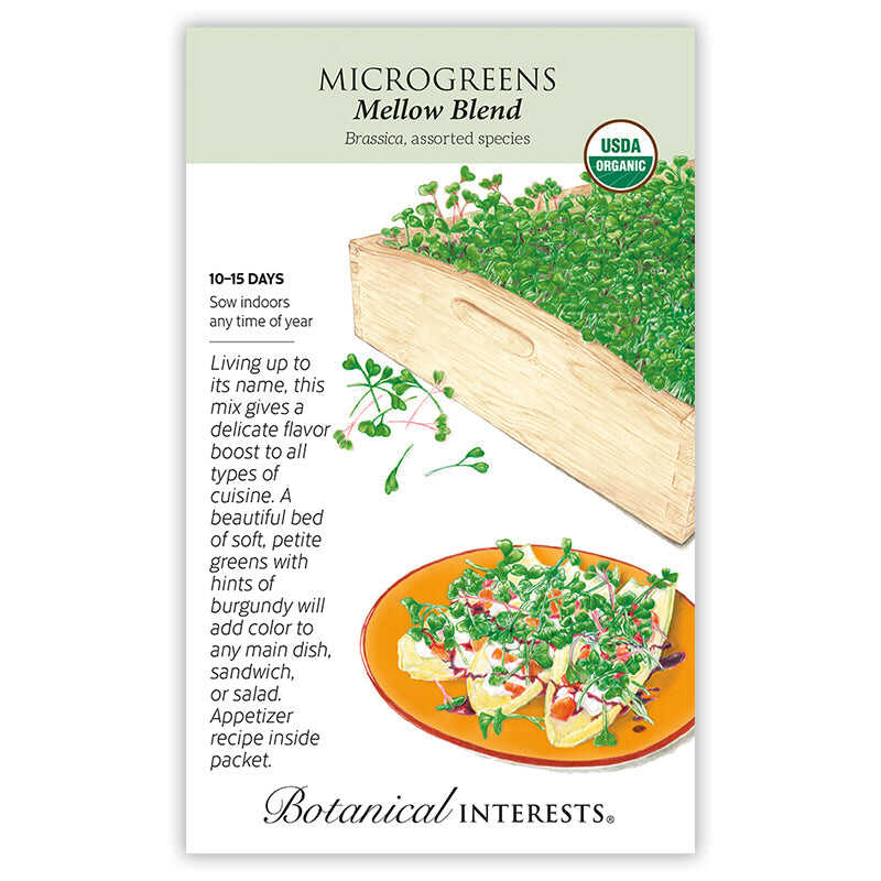 Seed packet for Mellow Blend Microgreens (Brassica, USDA Organic) illustrated with a wooden tray of dense green sprouts tinged with burgundy and a plated appetizer garnished with the greens, alongside text noting 10–15 day germination, indoor sowing, and an included recipe.