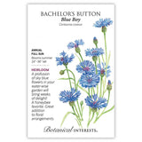 Seed packet for Blue Boy Bachelor's Button featuring an illustration of fringed sky-blue cornflowers with feathery petals on slender green stems, alongside text noting it's a full-sun annual heirloom growing 24–36 inches tall that blooms summer and attracts honeybees.