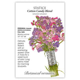 Seed packet for Cotton Candy Blend Statice illustrating a ribbon-tied bouquet of papery pink and purple flowers on long green stems, with text noting it's a full-sun perennial grown as an annual, blooming summer at 24–32 inches tall.