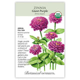 Seed packet for Giant Purple Zinnia showing an illustration of large fully double magenta-purple blooms on tall leafy stems, with a USDA Organic seal and text noting it's a full-sun annual growing 3 to 4 feet tall, blooming summer to frost, attracting butterflies and suited for cut flowers.