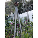 Zinc pyramid-shaped metal Akoris Garden Obelisk Large trellises with bronze sphere finials set among lush green foliage and purple flowering plants