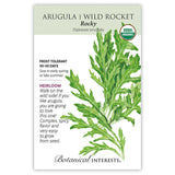 Seed packet for Rocky Arugula/Wild Rocket, an heirloom USDA organic variety, illustrated with a deeply lobed, jagged-leaved green frond, with text noting it's frost tolerant, matures in 30-50 days, and has a complex, spicy flavor.