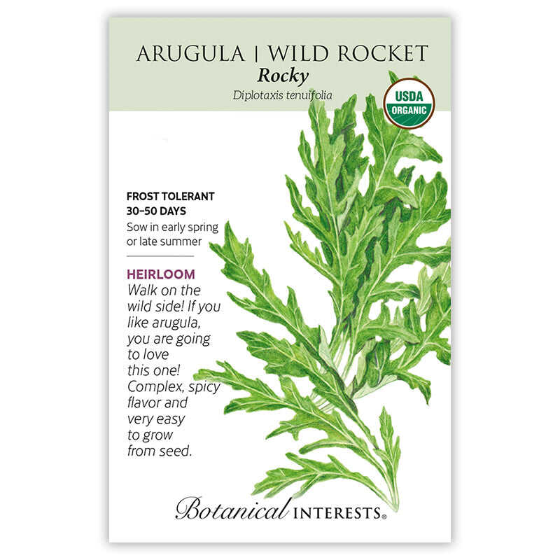 Seed packet for Rocky Arugula/Wild Rocket, an heirloom USDA organic variety, illustrated with a deeply lobed, jagged-leaved green frond, with text noting it's frost tolerant, matures in 30-50 days, and has a complex, spicy flavor.