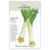 Seed packet for King Richard organic leek featuring a botanical illustration of two leeks with long white stalks, tangled roots, and broad green leaves, alongside text noting frost tolerance, 75-day maturity, spring or summer sowing, and a description of its mild onion flavor.