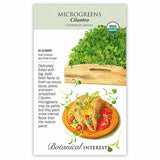 Botanical Interests organic Cilantro Microgreens seed packet illustrating a wooden tray of frilled green sprouts and tacos garnished with microgreens, with text noting 14–21 days to grow and indoor sowing year-round.
