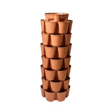 Terracotta-coloured GreenStalk 7-tier vertical planter, a tall stacked tower of interlocking pots with three planting cups per tier arranged around the column, shown empty against a white background.
