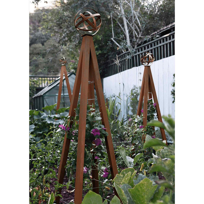 Oxide pyramid-shaped metal Akoris Garden Obelisk Large trellises with bronze sphere finials set among lush green foliage and purple flowering plants