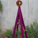 Purple metal A-frame Bird Cafe with Trellis topped with a circular oxide steel bird feeder, featuring orange flowers climbing the trellis