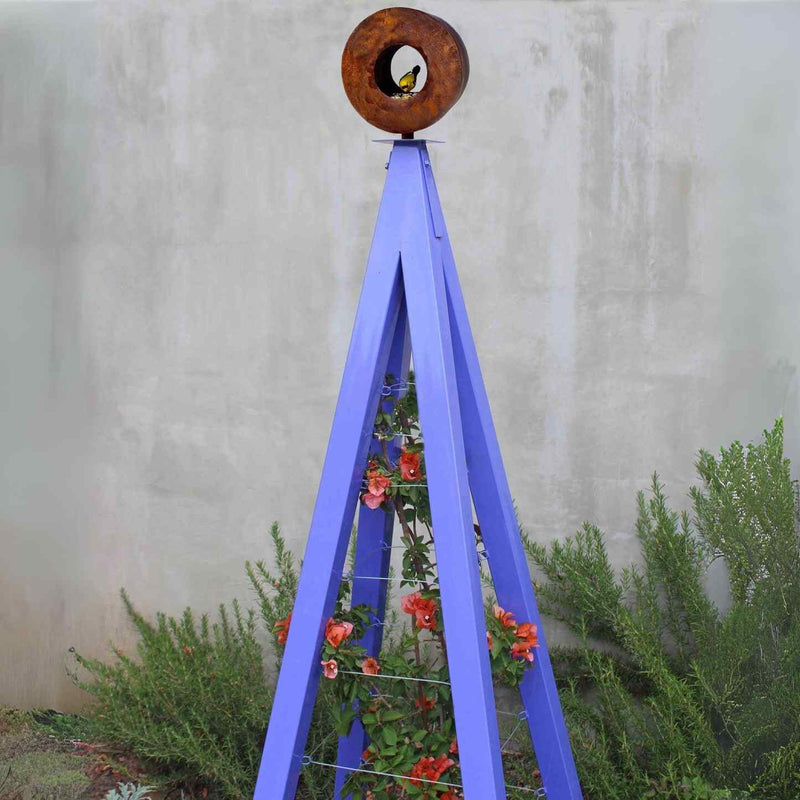 Aubergine metal A-frame Bird Cafe with Trellis topped with a circular oxide steel bird feeder, featuring orange flowers climbing the trellis