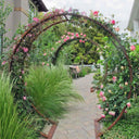 Rust-finished circular metal Gracie Modern Arbor creating an arched garden entryway covered in pink climbing roses