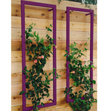 Two purple metal rectangular Ina Wall Trellises mounted on a light wood wall with flowering vines climbing through their wire grids