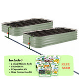 Two mist green corrugated raised garden beds with soil inside, connected by a black hose of the epic irrigation system on a white background. A light green banner at the bottom lists included items: 2 15-inch tall large raised beds, 1 starter kit, 1 expansion kit, and hose connection kit, with a small seed packet collage and the words 'FREE SEED'.