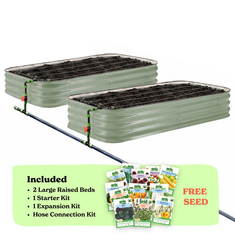Two mist green corrugated raised garden beds with soil inside, connected by a black hose of the epic irrigation system on a white background. A light green banner at the bottom lists included items: 2 15-inch tall large raised beds, 1 starter kit, 1 expansion kit, and hose connection kit, with a small seed packet collage and the words 'FREE SEED'.