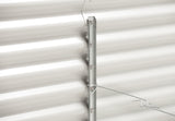 Metal bracket attached to a white corrugated metal wall