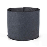 Empty round dark grey fabric grow bag with black stitched rim, shown standing open on a plain white background.