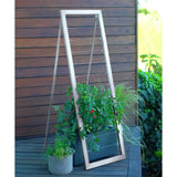 Silver metal frame A-frame Mira Garden Trellis with black-eyed Susan vines climbing up the grid wire, positioned in front of a concrete wall
