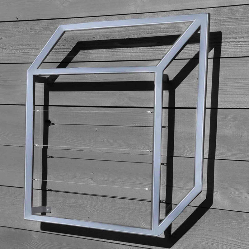 Silver cubic metal Pablo Wall Trellis mounted on a horizontal wood panel wall, throwing geometric shadows