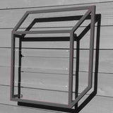 Silver cubic metal Pablo Wall Trellis mounted on a horizontal wood panel wall, throwing geometric shadows