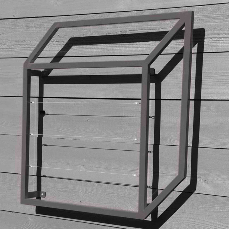 Silver cubic metal Pablo Wall Trellis mounted on a horizontal wood panel wall, throwing geometric shadows