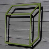 Green powder-coated cubic metal Pablo Wall Trellis mounted on a wooden wall, casting a geometric shadow