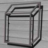 Gray cubic metal Pablo Wall Trellis mounted on a horizontal wood panel wall, throwing geometric shadows