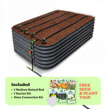 A raised garden bed in slate gray color filled with soil, shown with drip irrigation tubing laid across the top. A light green promotional banner at the bottom lists included items: 1 29-inch tall medium raised bed, 1 starter kit, and hose connection kit, with a small image of seed packets and the text 'Free Seed & Plant Tags'.