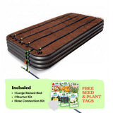A raised garden bed in slate gray color filled with soil, shown with drip irrigation tubing laid across the top. A light green promotional banner at the bottom lists included items: 1 15-inch tall large raised bed, 1 starter kit, and hose connection kit, with a small image of seed packets and the text 'Free Seed & Plant Tags'.