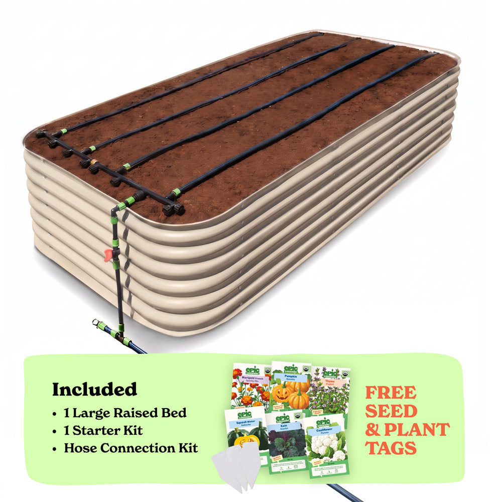A 29-inch large raised garden bed in light clay color filled with soil, shown with drip irrigation tubing laid across the top. A light green promotional banner at the bottom lists included items: 1 large raised bed, 1 starter kit, and hose connection kit, with a small image of seed packets and the text 'Free Seed & Plant Tags'.
