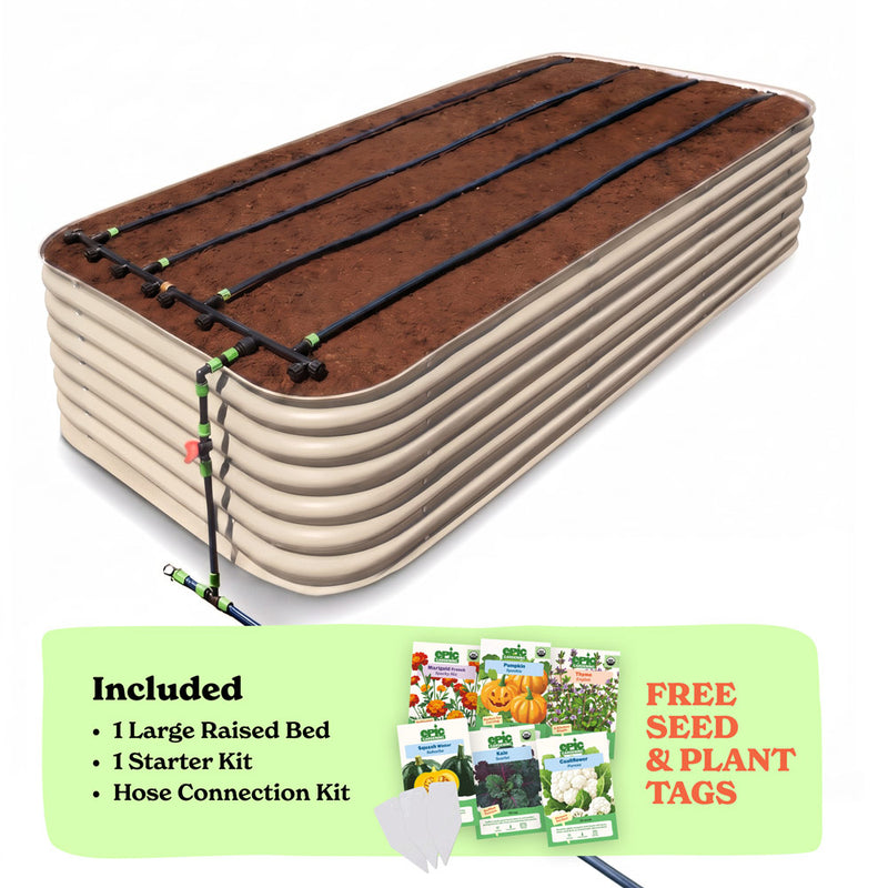 A 29-inch large raised garden bed in light clay color filled with soil, shown with drip irrigation tubing laid across the top. A light green promotional banner at the bottom lists included items: 1 large raised bed, 1 starter kit, and hose connection kit, with a small image of seed packets and the text 'Free Seed & Plant Tags'.