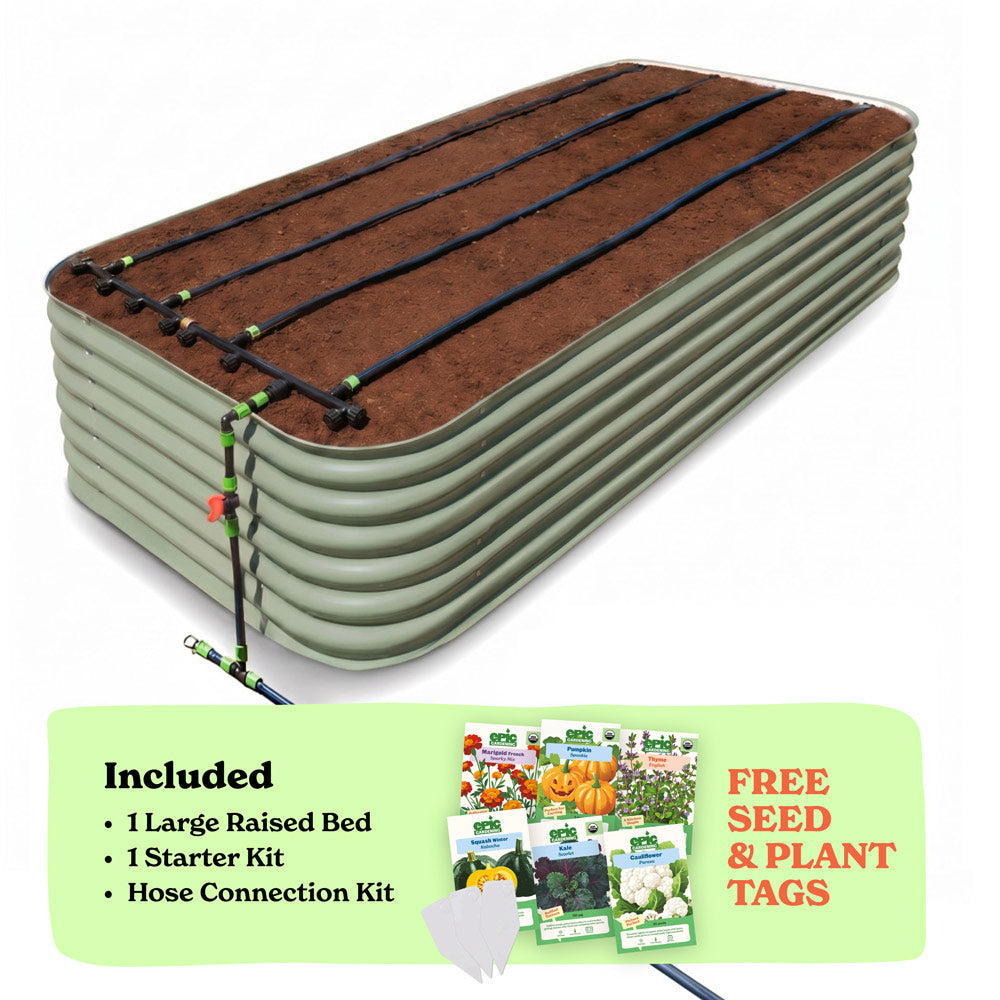 A 29-inch large raised garden bed in mist green color filled with soil, shown with drip irrigation tubing laid across the top. A light green promotional banner at the bottom lists included items: 1 large raised bed, 1 starter kit, and hose connection kit, with a small image of seed packets and the text 'Free Seed & Plant Tags'.