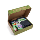 Open cardboard box of the "Buzz Bloom Epic Garden in a Box" containing a grow bag and seed packets with 'Keep On Growing' text.