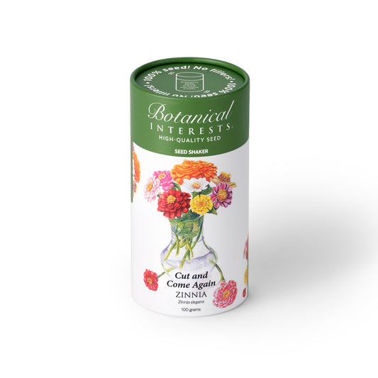 Botanical Interests Cut and Come Again Zinnia 100-gram seed shaker tube on a plain white background, featuring a green lid and floral illustration of colorful zinnia blooms in a vase.