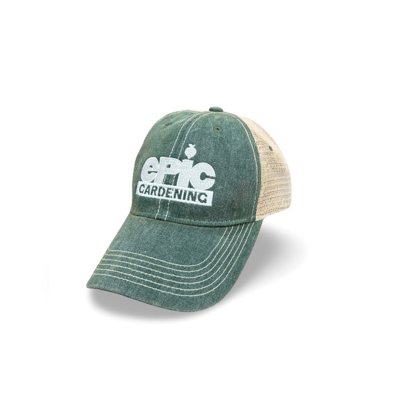 Side profile view of the dark green trucker-style cap, showcasing the curved brim, structured front panels, and breathable green mesh back panels on a plain white background.