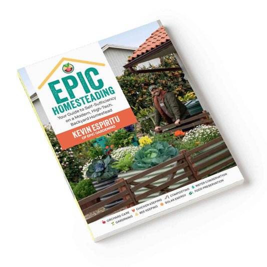 Paperback cover of "Epic Homesteading" by Kevin Espiritu, showing a man leaning on a raised garden bed full of cabbages and flowers, with icons along the bottom listing topics like orchard care, chicken keeping, composting, and solar energy.