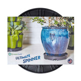 GreenStalk Ultimate Spinner, a round black wheeled rotating base, shown on packaging featuring a large blue-glazed planter and a stacked green tiered garden tower, with text noting it is made in the USA.