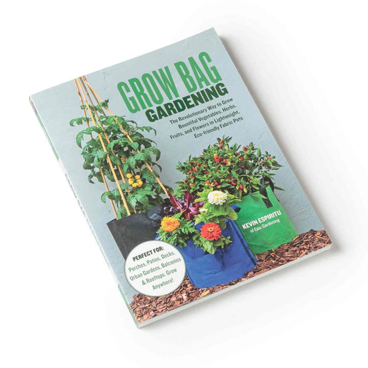 Paperback book "Grow Bag Gardening" by Kevin Espiritu, its cover photo showing staked tomatoes, peppers, beets and marigolds thriving in black, blue and green fabric grow bags, with cover text noting suitability for porches, patios, balconies and rooftops.