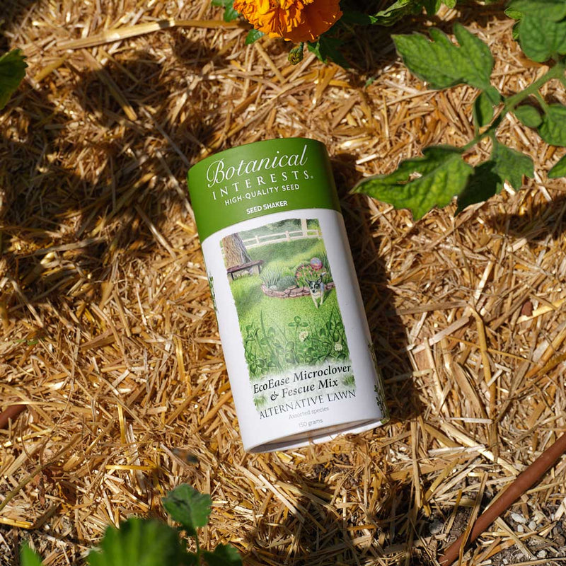 Botanical Interests EcoEase Microclover and Fescue Mix Alternative Lawn Seed Shaker on mulched ground with plants around