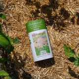 Botanical Interests White Clover Alternative Lawn Seed Shaker container or canister on straw with plants around