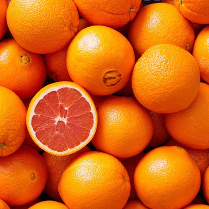 Stack of Cara Cara oranges with a halved grapefruit on top
