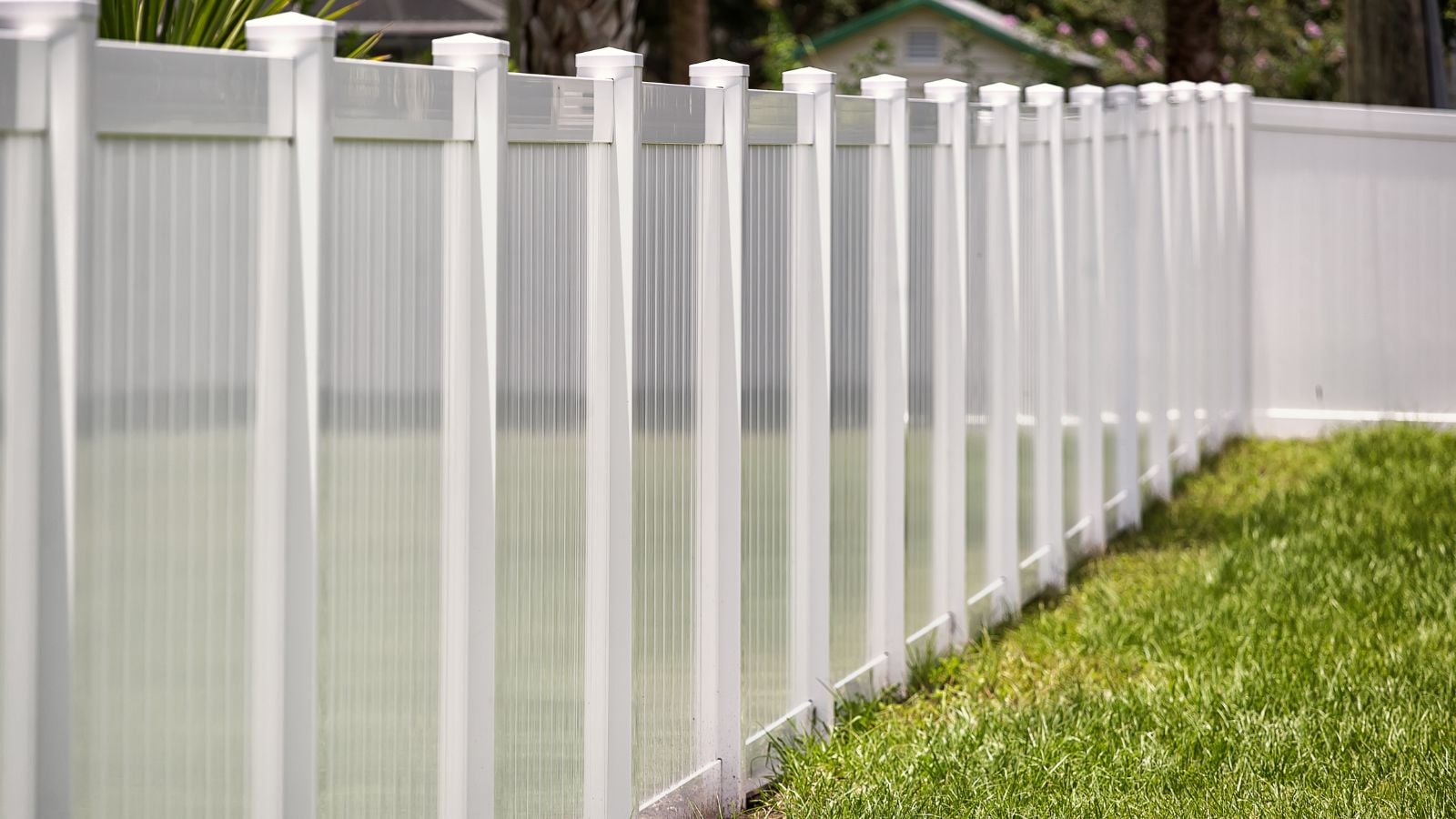 A close-up shot of a PVC Vinyl fencing, placed on the borders of a yard area outdoors