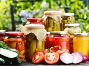 A close-up shot of a composition of various jarred crops, showcasing the best vegetables to preserve