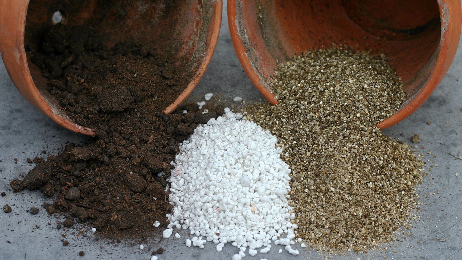 A shot of several pots that are tipped over showcasing various soil amendments, appearing to include different types of material with varying colors