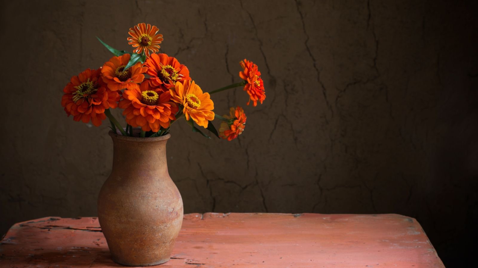 A close-up shot of a small bouquet of flowers on a vase in a cool area indoors
