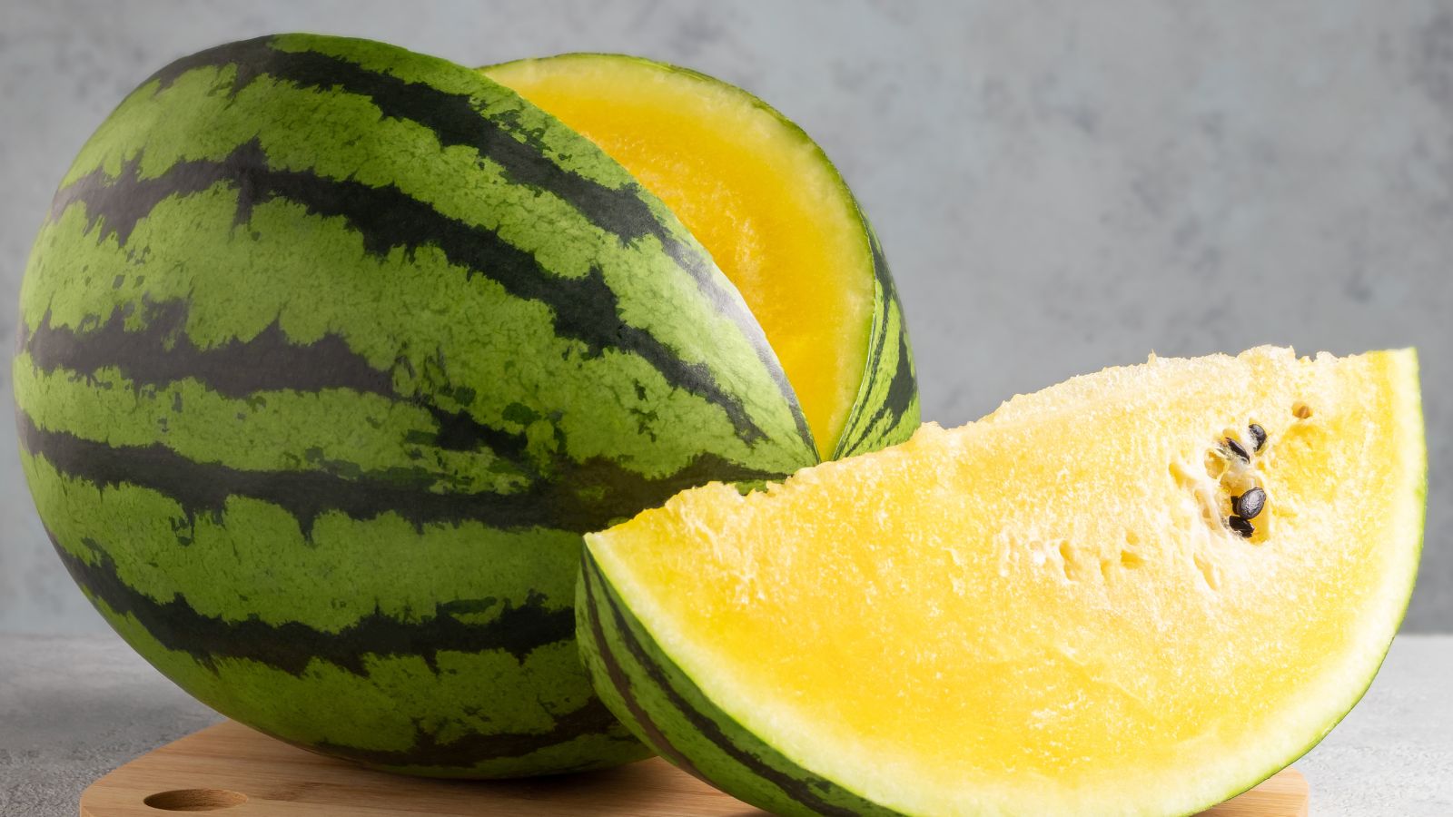A shot of a compact and round fruit with a yellow flesh, called the Citrullus lanatus ‘Yellow Petite’