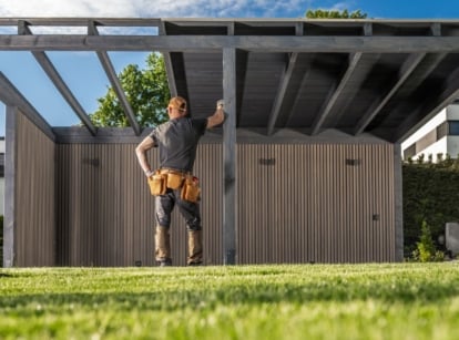 A shot of a person standing near a garden structure project, showcasing a waste of time landscaping