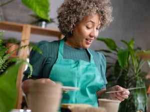 A mature woman choosing through slow germinate plants start January, appearing to look through different options to start indoors