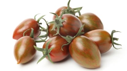 An isolated shot of several freshly harvested, brown, striped fruits, all placed on a white surface