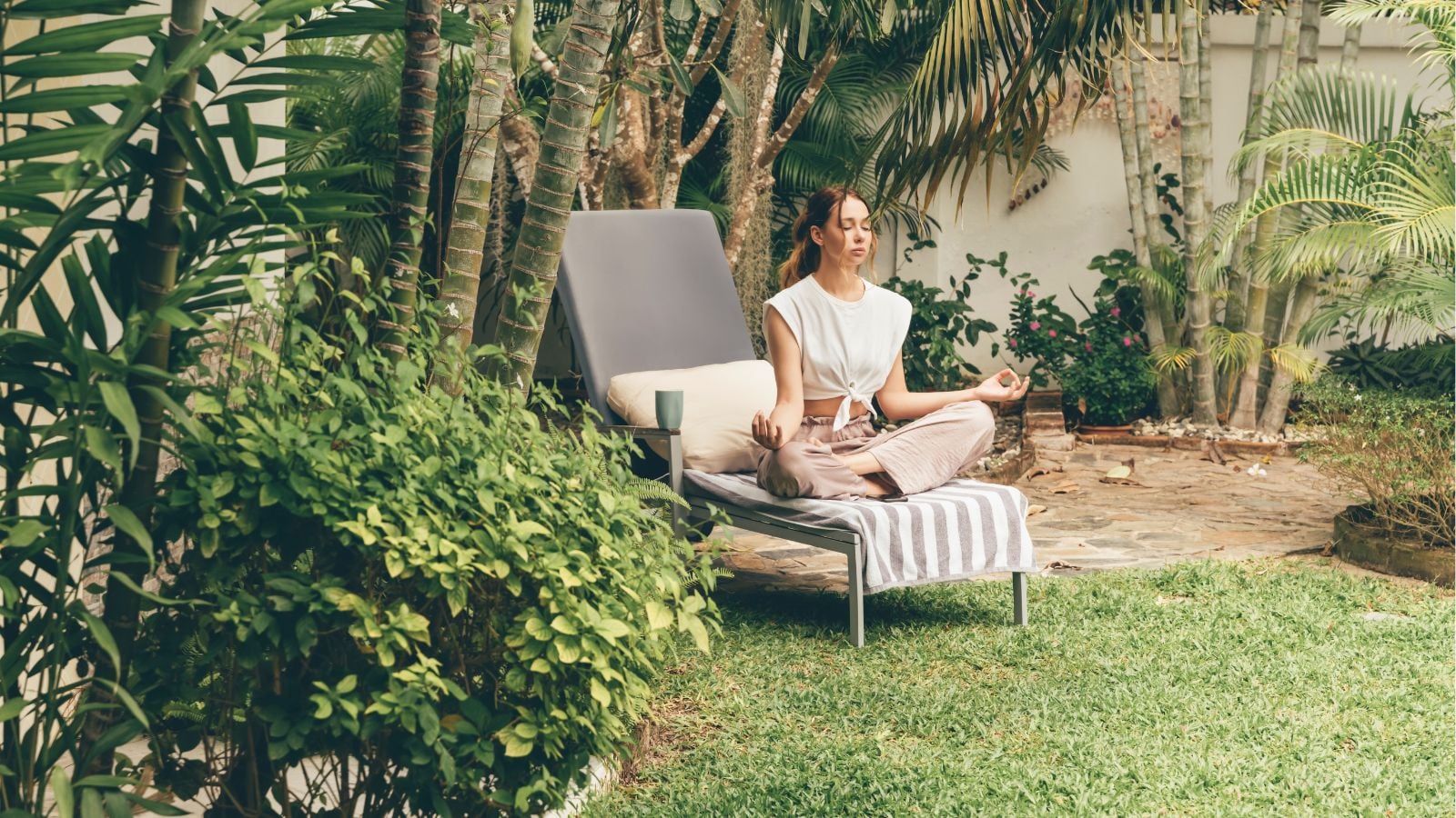 A person in the process of pondering and relaxing while sitting on a comfortable reclined chair in a cozy yard area