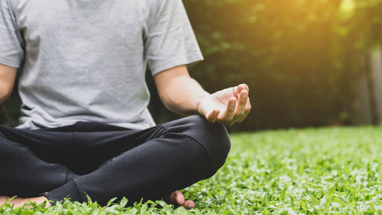 A close-up shot of a person in the process of relaxing and pondering, showcasing how to create a meditation garden